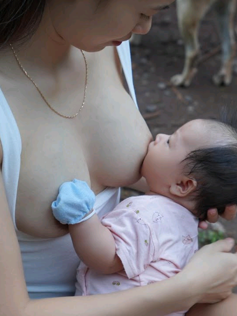 @amanda0219997 breastfeeding. The beautiful single mother takes care of her youn...